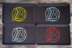 Full lineup of Brian Brown EDC Valet Trays displaying all four logo color options—yellow, red, white, and blue—arranged side by side for comparison