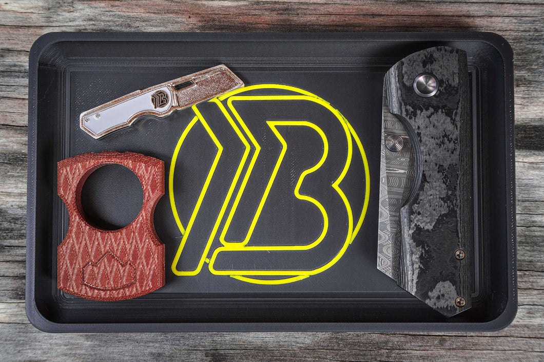 Brian Brown EDC Valet Tray featuring a yellow 'B' logo, shown on a flat surface with space for knives, keys, and other everyday carry items