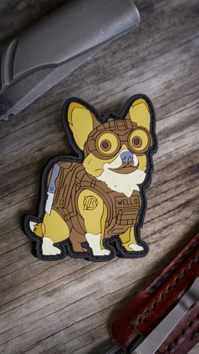 Tactical Wells PVC Patch featuring a corgi in full gear with night vision goggles, plate carrier, and Yeager-M rifle