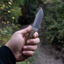 Load image into Gallery viewer, Hand holding a fixed blade knife with a natural background