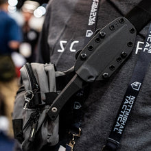 Load image into Gallery viewer, Person wearing a tactical knife sheath on a bag with 'Notingham Tactical' branding.