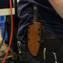 Load image into Gallery viewer, Person wearing a knife sheath on their belt with a blurred background